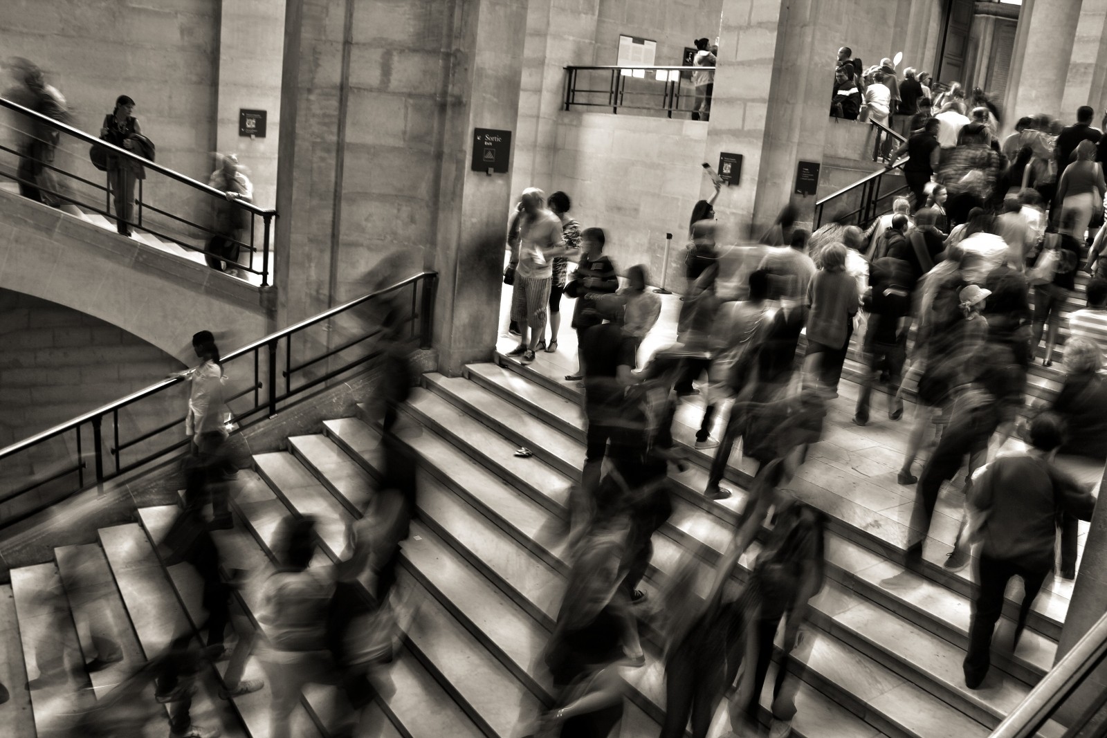 black-and-white-image-of-people-walking-in-underground