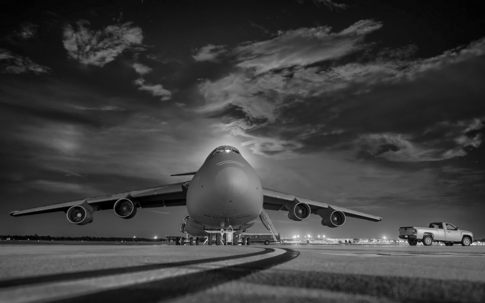 huge-military-aircraft-on-grassy-runway-mono